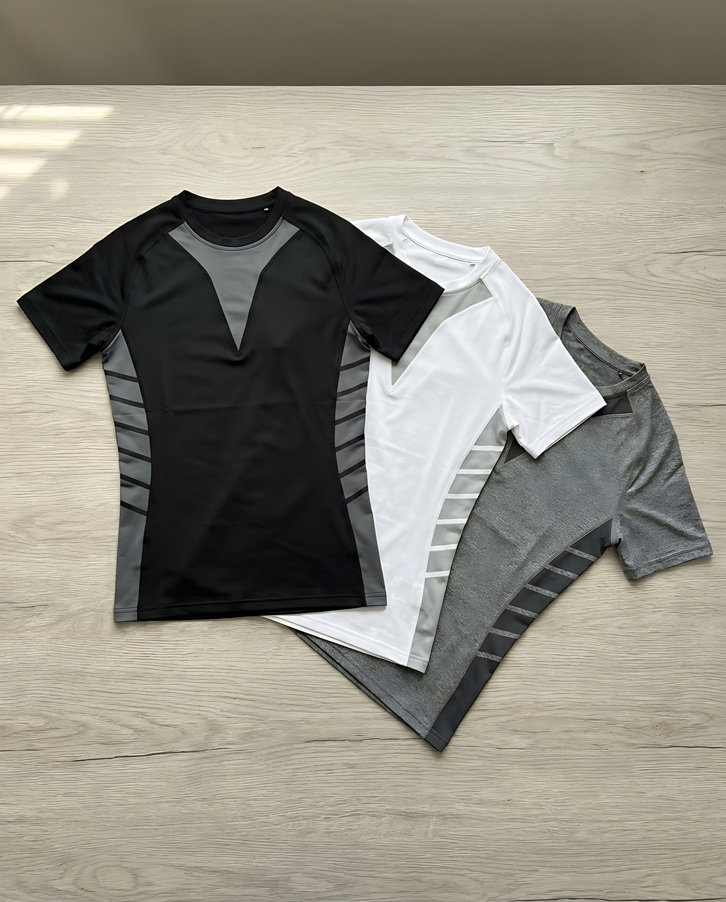 Shieldwall compression tee in black, white and grey laid flat