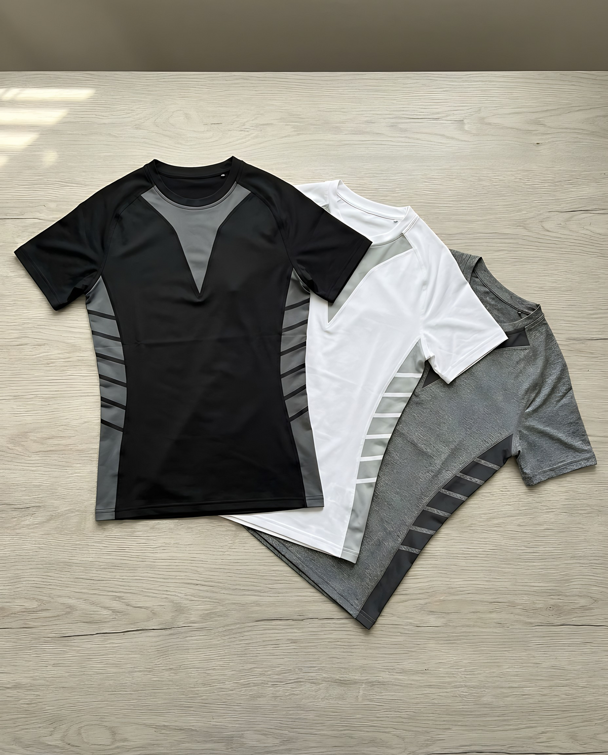 Shieldwall compression tee in black, white and grey laid flat