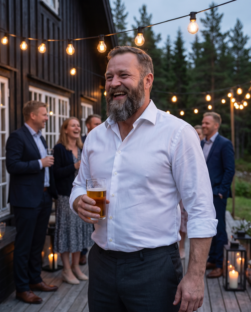 Man laughing at an evening wedding in a crisp white dress shirt
